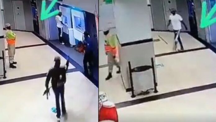 Moments hired Security guard calmly walks away as armed men rob a man at the ATM (Video)